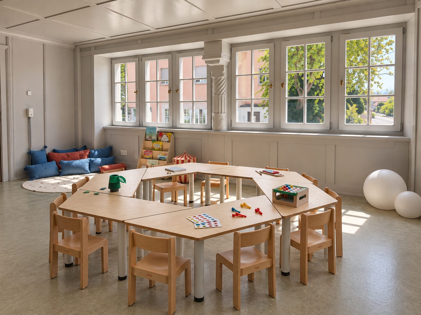 Low tables and small chairs in the group room, set up for a shared meal
